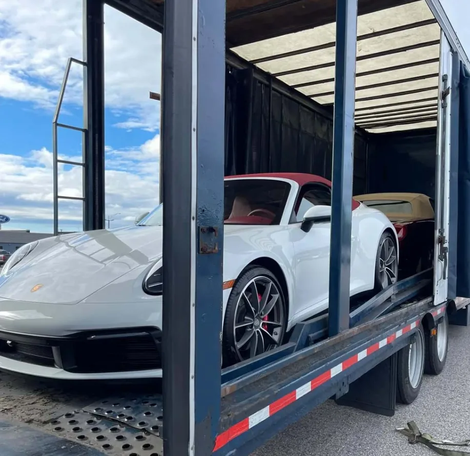 Enclosed car shipping trailer protecting a vehicle during transport