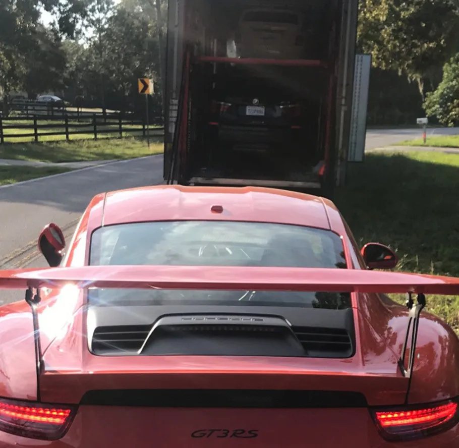 Exotic car being shipped in an enclosed carrier